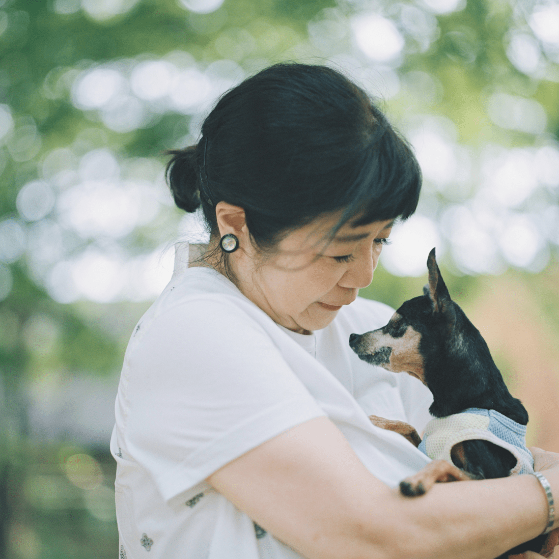 愛犬を抱えている女性。